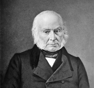 Black and white portrait of a middle-aged man with white hair, wearing a formal coat and a stern expression.
