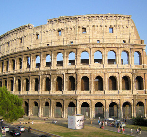 The Colosseum in Rome, showcasing its ancient architecture against a clear blue sky.