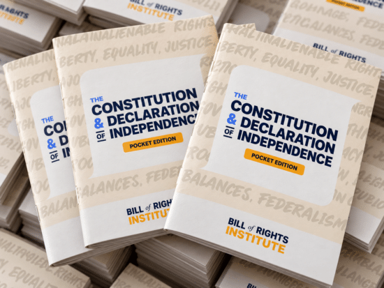 Stack of pocket edition books titled "The Constitution & Declaration of Independence" from the Bill of Rights Institute.