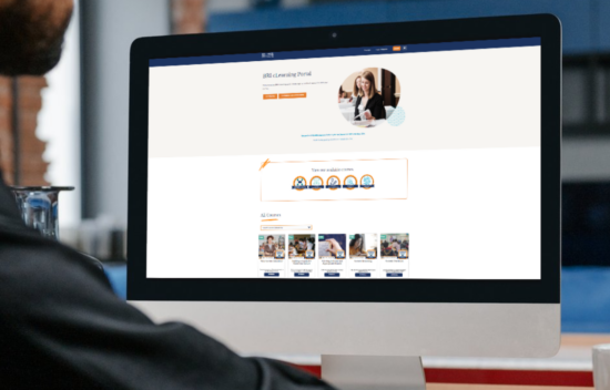 A person working on a desktop computer displaying a website with various images and information.