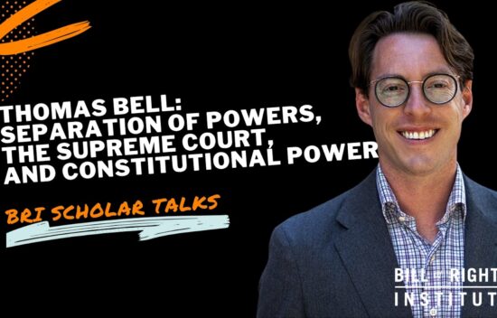 Man with glasses smiling, speaking at a BRI Scholar Talk about the Supreme Court and constitutional power.