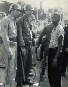 Two Arkansas National Guard members face Terrence Roberts at Little Rock Central High School on September 23 1957