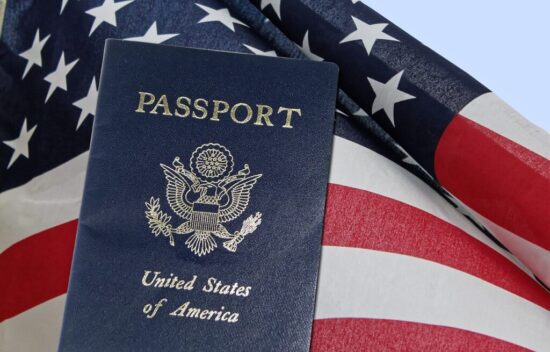 A United States passport resting on an American flag.